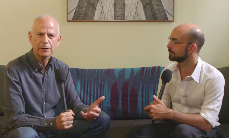 Alan Schwartz and Philip Bateman sitting on a sofa talking