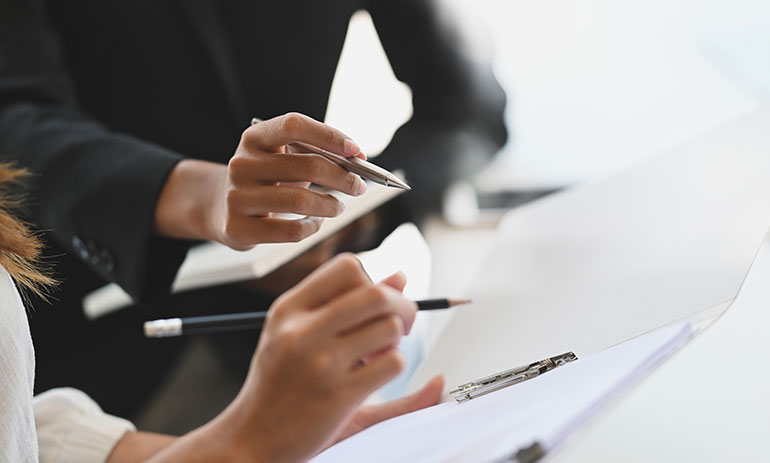 close up of two people checking a document