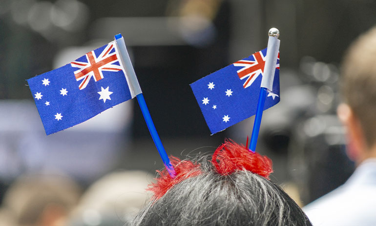woman wearing the Australian flag in her hair watching Australia Day parade