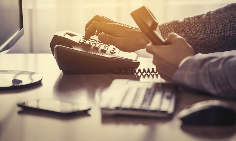 Person making a phone call in office