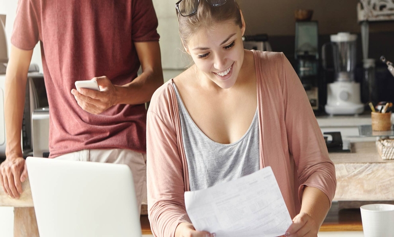 woman smiling looking at a piece of paper