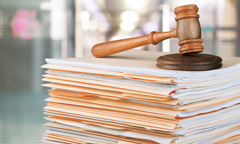 gavel and block on top of paper stack