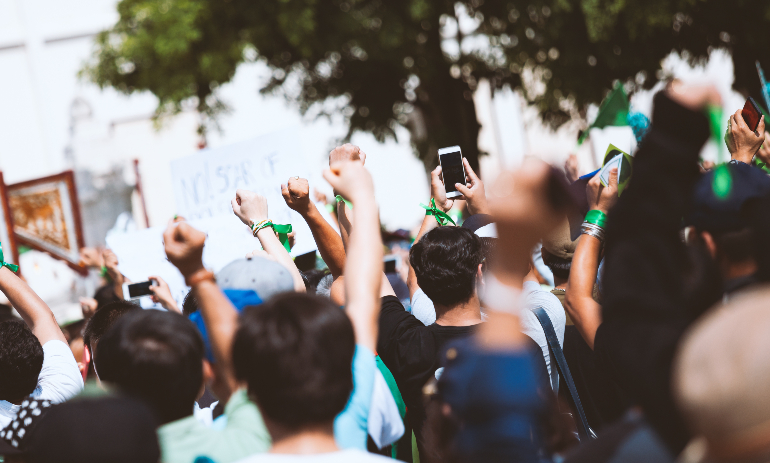 rally crowd with raised fists