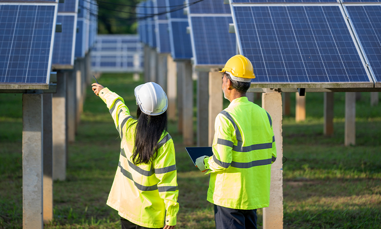 people in hi vis looking at solar panels