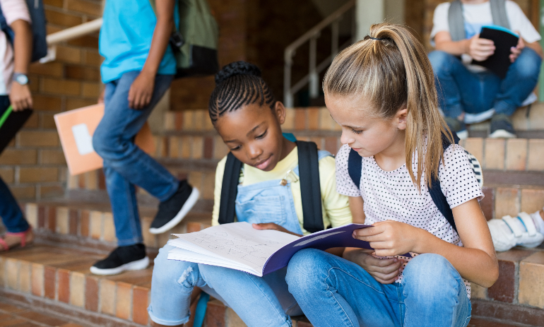 Two school girls studying