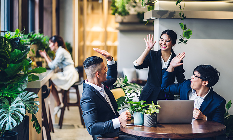 office workers high fiving