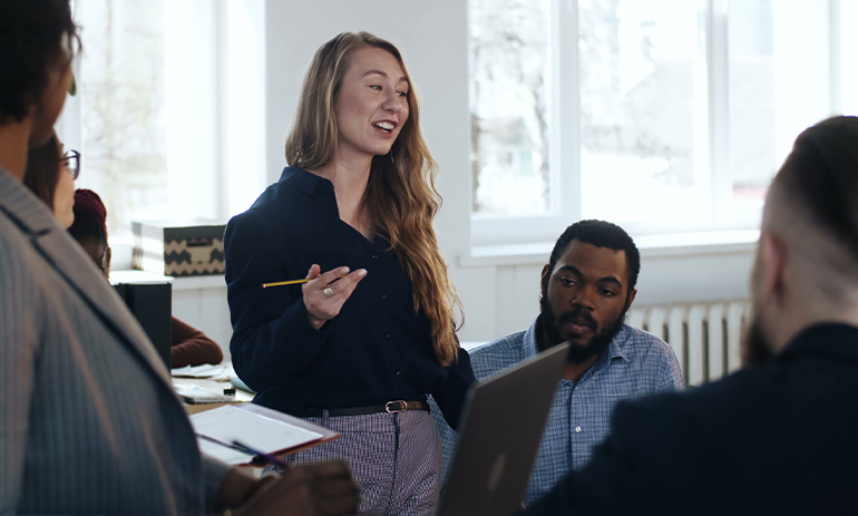 woman pitching an idea to a group of people informally