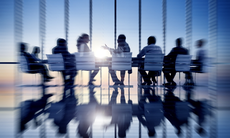 people sitting around meeting table