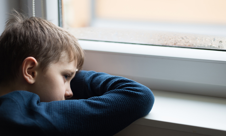 sad boy in window