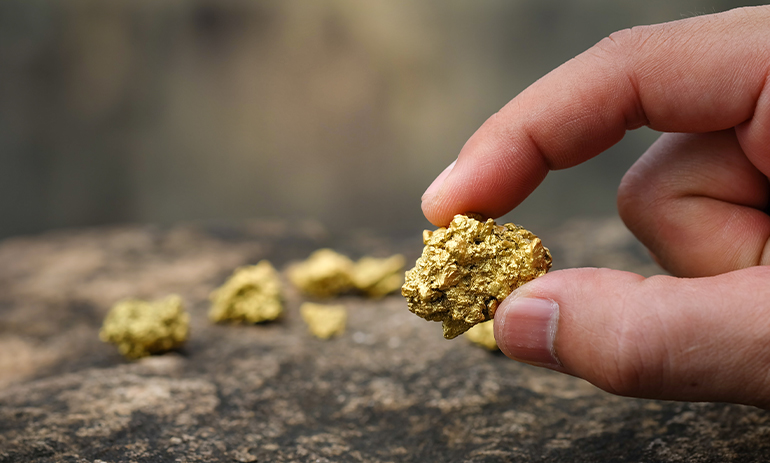 hand holding a golden nugget