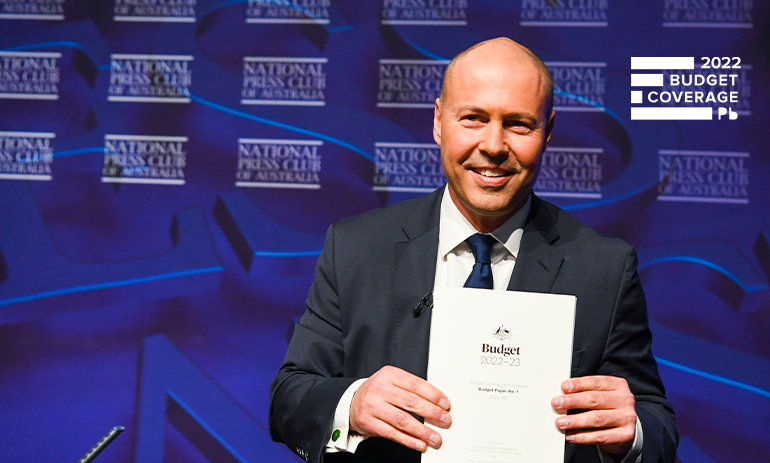 Australian Treasurer Josh Frydenberg poses with the 2022 Budget papers ahead of delivering his post budget National Press Club address in the Great Hall of Parliament House in Canberra