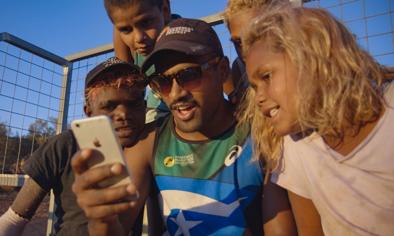 group of people looking at a phone