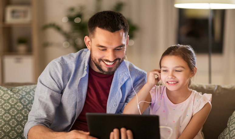 Father and daughter listen to podcast