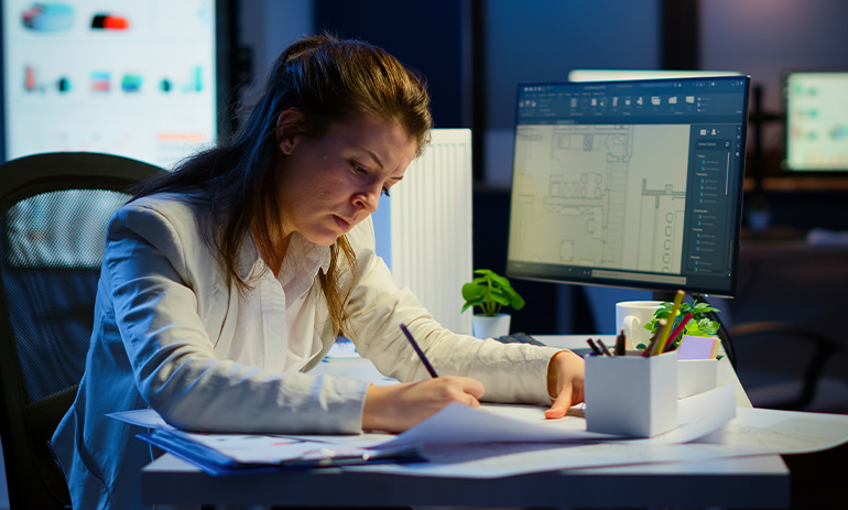 woman sitting at desk hard at work