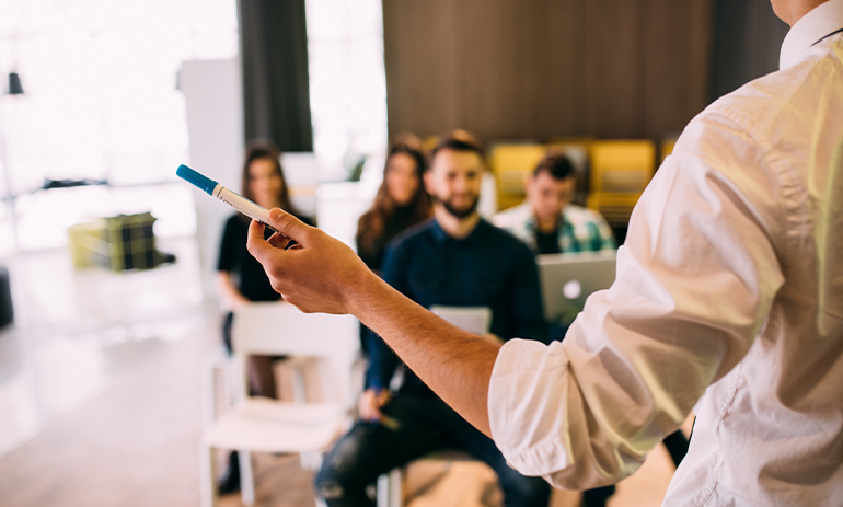 person in a white shirt teaching a group of people