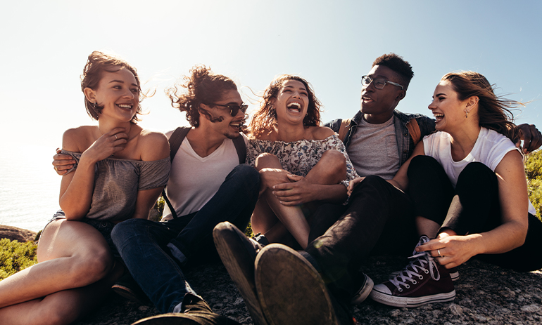 group of young people sitting and smiling