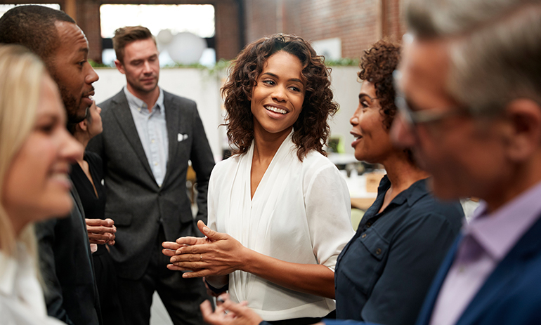 group of diverse people standing talking